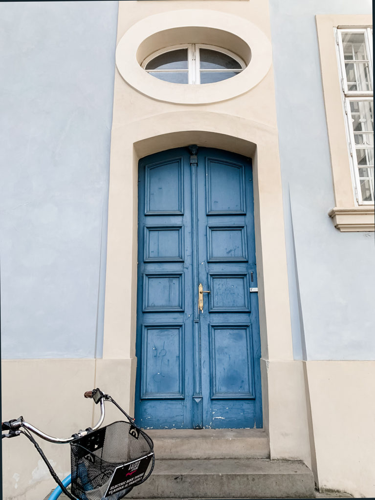 prague design inspiration blue door circle window pale blue wall